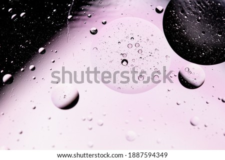 Abstract science concept background with oil drop in water. Monochromatic effects with blurred and sharpen circles together. Stiring water and oil. Chemical and space science concept image