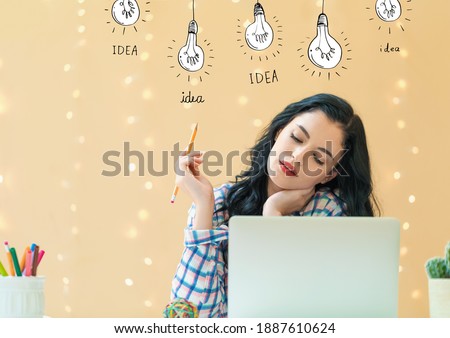Idea light bulbs with young woman holding a pencil
