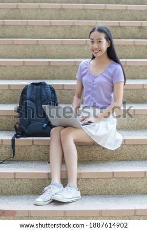 College asian student female sitting on staircase. Asian People