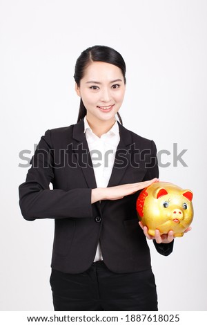 A business woman carrying a piggy bank high quality photo
