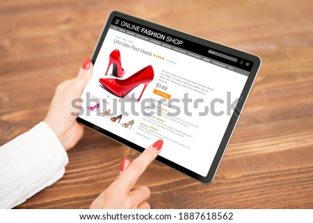 Woman shopping for new high heel shoes online on tablet computer