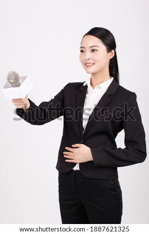 A business woman holding the microphone to interview high quality photo