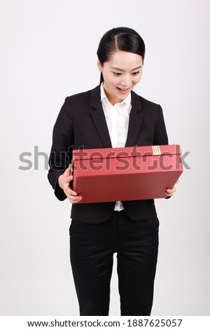 A business woman carrying a gift box high quality photo