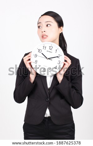 A young business woman holding a clock high quality photo