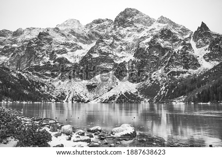 Black and white picture of frozen Morskie Oko Lake (Eye of the Sea) in Tatra National Park, Poland.