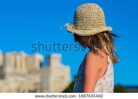 Little girl on the background of the Acropolis in Athens, Greece.
