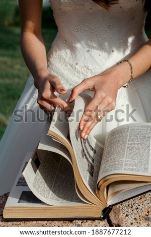 Hands of the bride, who turns the pages of a thick book in Turkey