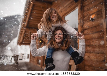 Mother and daughter in winter chalet Royalty-Free Stock Photo #1887683830