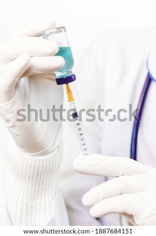 Doctor filling syringe with medication, closeup. Vaccination and immunization. Selective focus. Vaccine.