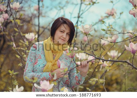 spring garden pink magnolia and a girl in a yellow scarf