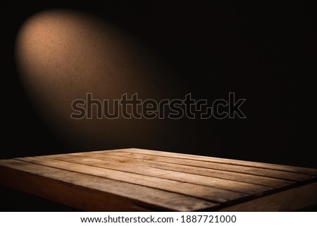empty wooden table for groceries on dark background