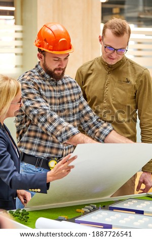architects and engineers working with blueprints and architectural plan, female director talk with engineer, discuss building design,Home or house town planning Royalty-Free Stock Photo #1887726541