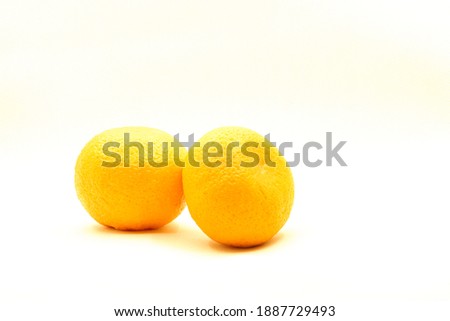 Two mandarins on the pastel light white background. 