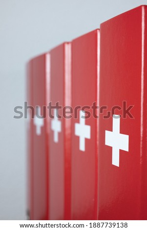 Red folders with a white cross - imitation of a swiss flag 