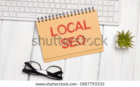 Local SEO. Text in lightbox. White desk with stationery