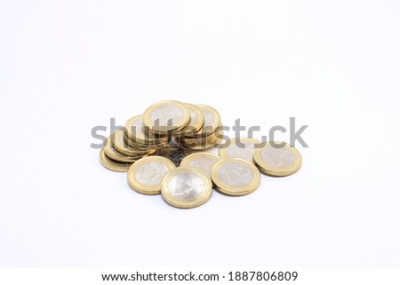Couple of new one (1) Euro coins with reverse side up (number side on top). Isolated on white background.