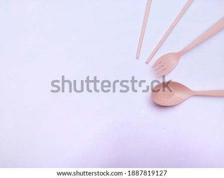 Pink cutlery made of wheat straw isolated on white background. Copy space. Reusable and Eco Friendly