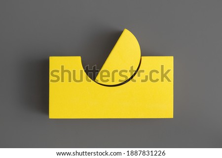 Flat lay composition of yellow geometric shapes on gray background. Colors of the Year 2021 Illuminating and Ultimate gray. Minimalism concept.