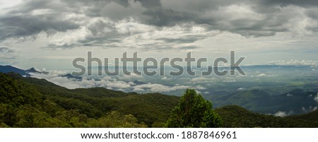Panoramic view of mountains and clouds over the city of Campos do Jordao.