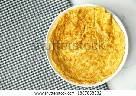 Top view of Omelet , Omelette with onion served on the table. Simple and easy to cook. Still life food. Asian style. Copy space. Royalty-Free Stock Photo #1887858532