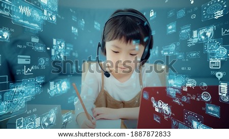Little girl taking a online class. Education technology. EdTech. Royalty-Free Stock Photo #1887872833