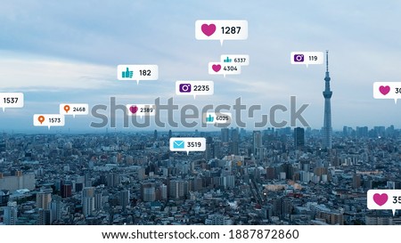 Notice balloons of social networking service pop-up above modern city. Social media. Royalty-Free Stock Photo #1887872860