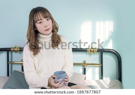 Lovely portrait of Asian woman in bedroom