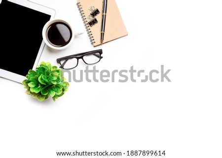 Flat lay, top view office table desk. Workspace with, laptop,office supplies, pencil, green leaf, and coffee cup on white background.