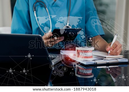 Double exposure of healthcare And Medicine concept. Doctor working with digital tablet and modern virtual screen interface icons, blurred background.