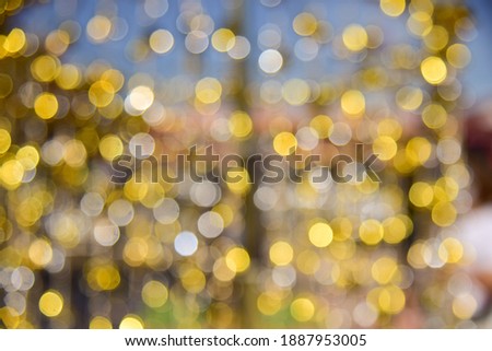 Blurred bokeh light gold backdrop.