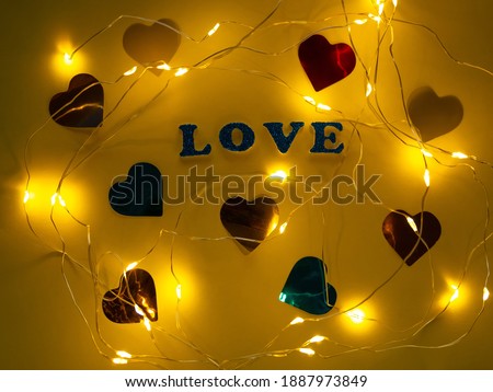 Valentine's Day Love glitter sign text on pastel yellow background hearts confetti, creative flatlay minimal concept. Greeting card top view social media sale banner design. Bright vebrant colors.