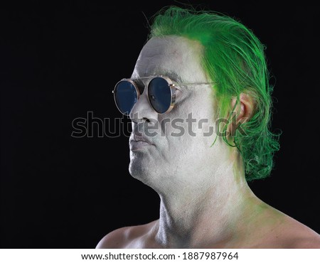 men with white makeup and green painted hair