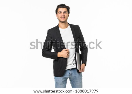 Full length portrait of a businessman walking with latpop over gray background