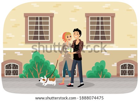 Couple with a dog walking together in the city park. Pet owners on a romantic date outdoors. Cute happy smiling girl and guy spend time in the open area against the background of a large building