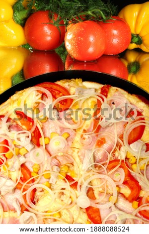 a large slice of delicious pizza with tomatoes, onions and corn