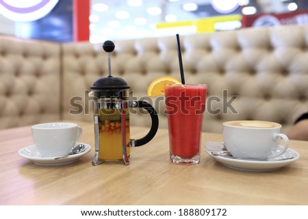 Various beverages on a wooden table in the cafe