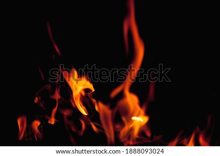 Beautiful pictures of fire flame against black background as symbol of hell and eternal pain in Christian tradition.. Horizontal image.