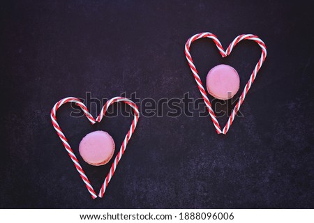Festive dark background. Hearts of sweet candies. Colorful macaroons. Christmas card. Valentine Day. 14 of February. Flat lay, top view.