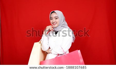 Asian hijab woman happy check shopping bag