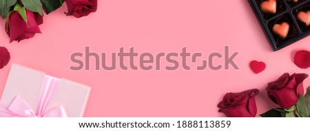 Valentine's Day design concept background with rose flower and gift box on pink background