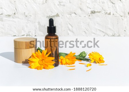 Natural cosmetics based on calendula. Skin care. Calendula flowers. Light background.