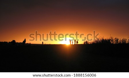 Sunset and silhouettes of people