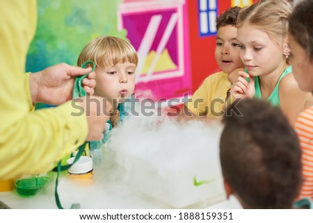 Experiment with dry ice for kids. Birthday party for kids steaming liquid. Concept of kids leisure.