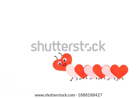 Funny paper caterpillar of red and pink paper hearts on a white background.Handmade greeting card for Valentine's Day and Mother's Day.Copy space for text.