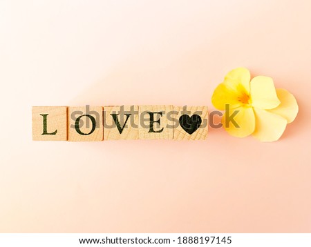 alphabet blocks  'LOVE'  with yellow flower