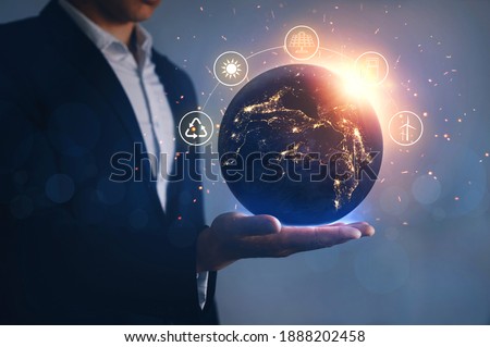 Night earth in the hands of man with icons energy sources for renewable. Eco development. Energy savings concept. Elements of this image furnished by Nasa.
