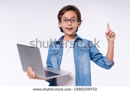 Smart small male kid having idea with laptop isolated over white background