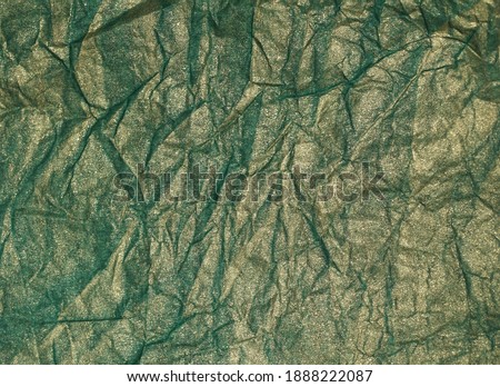  Crumpled gold shine Aquamarine paper background. Holiday decorate concept. Selective focus.