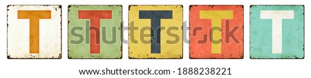 Five vintage tin signs on a white background - Letter T