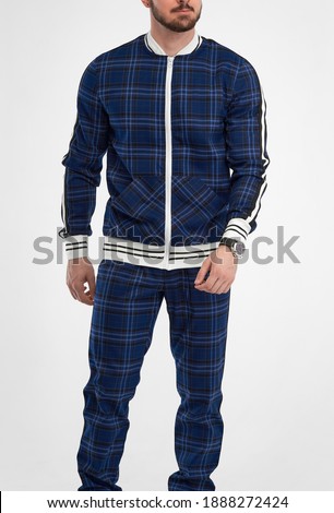 man wears checkered tracksuit. isolated picture of guy standing in sport suit gentleman.